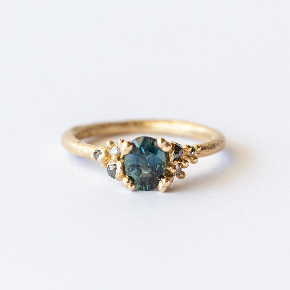 Ruth Tomlinson | Teal Sapphire and Diamond Encrusted Solitaire Ring