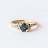 Ruth Tomlinson | Teal Sapphire and Diamond Encrusted Solitaire Ring