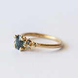 Ruth Tomlinson | Teal Sapphire and Diamond Encrusted Solitaire Ring