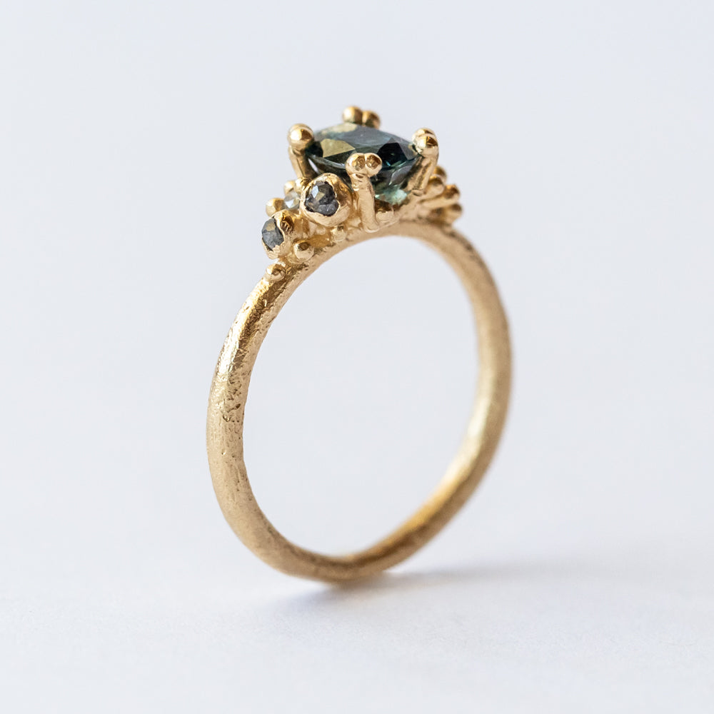 Ruth Tomlinson | Teal Sapphire and Diamond Encrusted Solitaire Ring