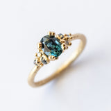 Ruth Tomlinson | Teal Sapphire and Diamond Encrusted Solitaire Ring
