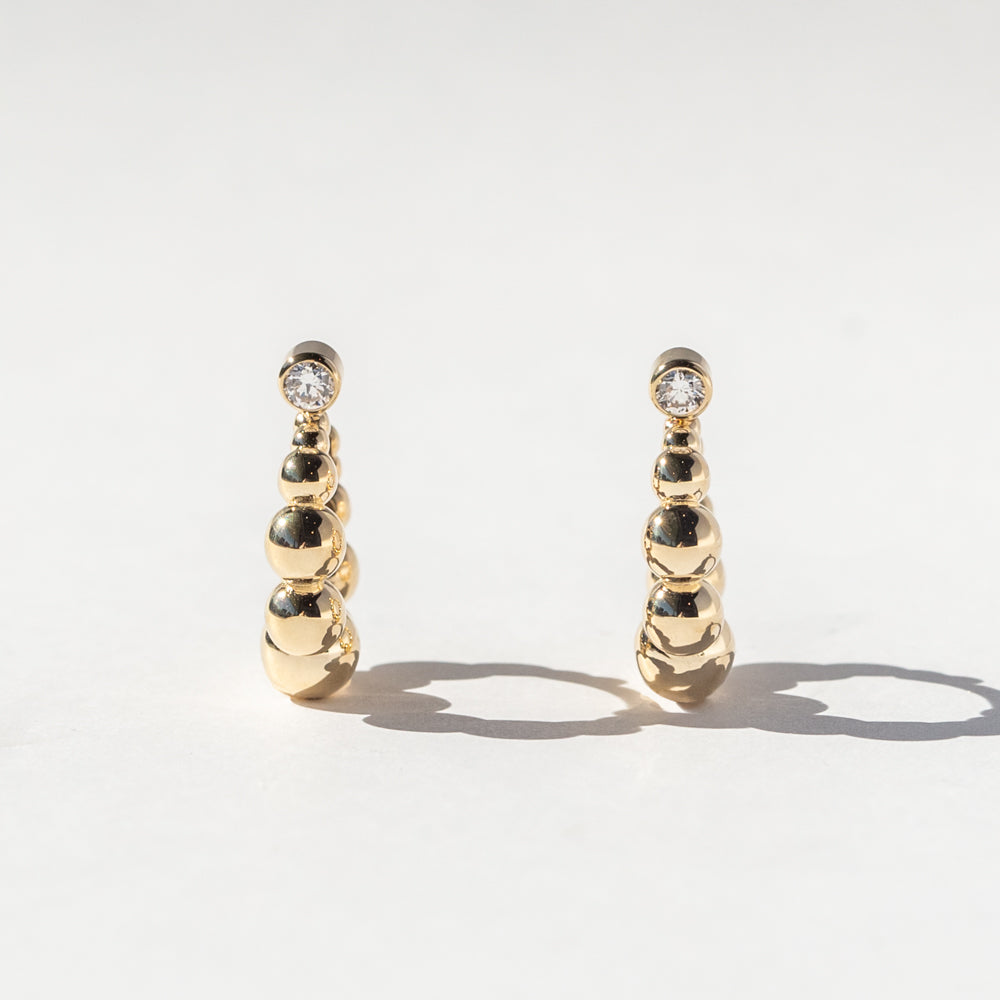 Graduated Bead Huggie Hoop Earrings with Bezel-Set Diamonds