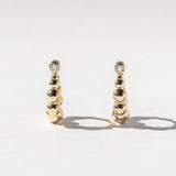 Graduated Bead Huggie Hoop Earrings with Bezel-Set Diamonds