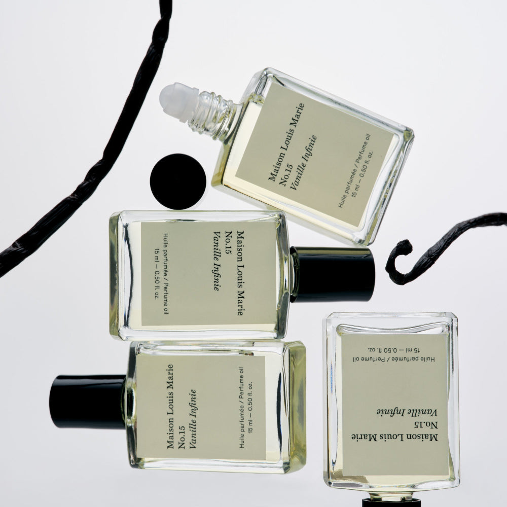Four perfume bottles with visible labels on a light gray background