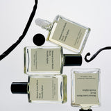 Four perfume bottles with visible labels on a light gray background