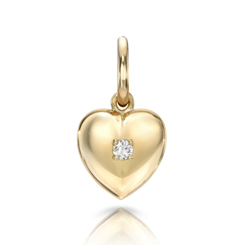 A yellow gold heart charm with a single round diamond set in the center.
