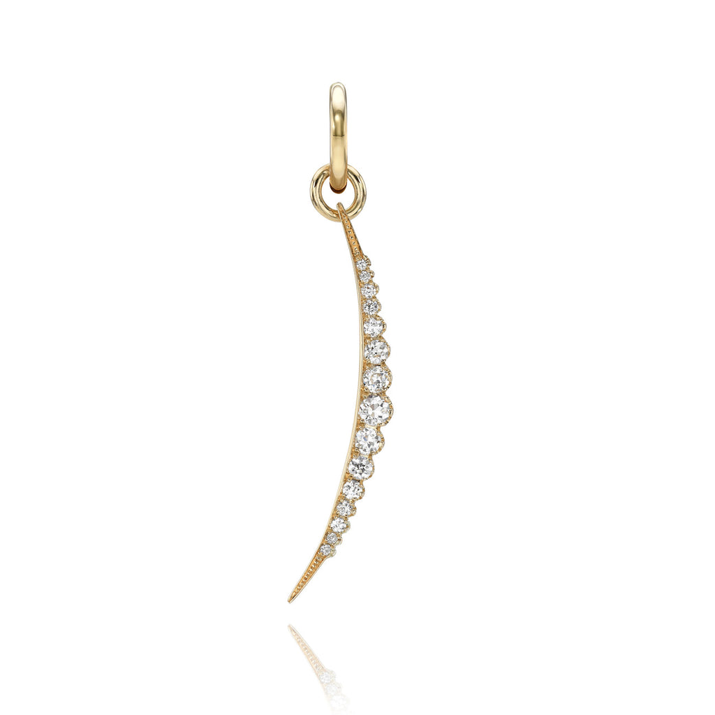 A slim, elongated crescent moon charm in yellow gold, set with a row of pave diamonds. 