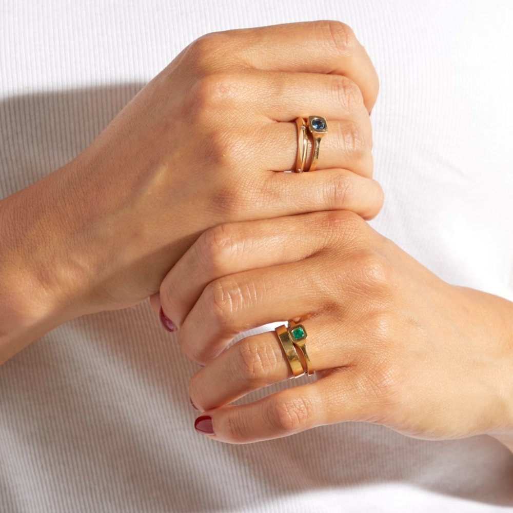 Yellow gold, square emerald solitaire ring from Adeline, on hand view.