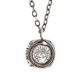 engraved silver and rose gold pendant of ouroboros.