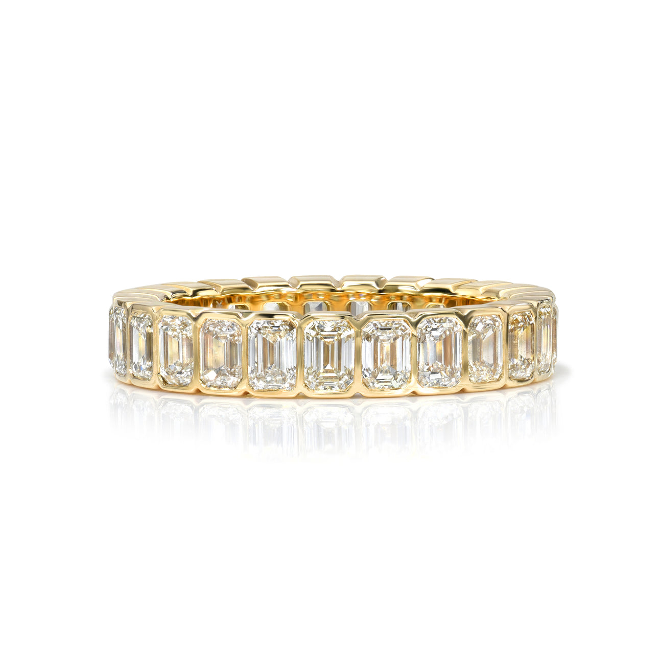 A yellow gold and diamond eternity band with bezel set emerald cut diamonds set vertically all the way around.