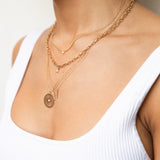 Zoe Chicco gold chain necklace with diamond, with other necklaces on model, angled front view