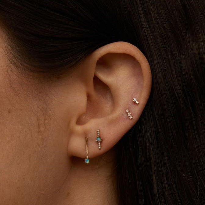 Wwake gold bar and opal stud earring on model, front view