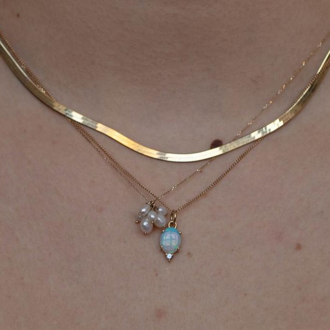 Wwake gold necklace with pearl cluster on model, front view