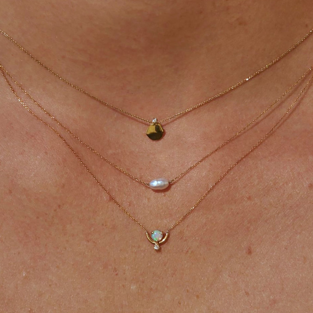 Wwake gold and pearl necklace on model, front view