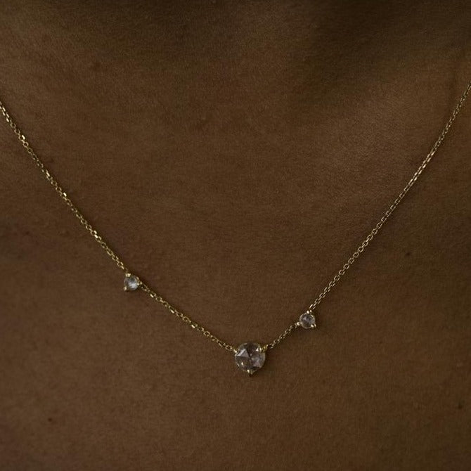 Wwake gold necklace with 3 diamonds on model, front view