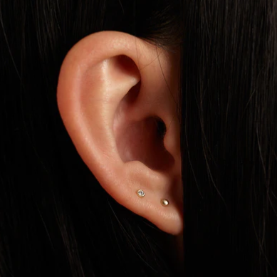 Wwake gold sphere stud earrings on model, front view