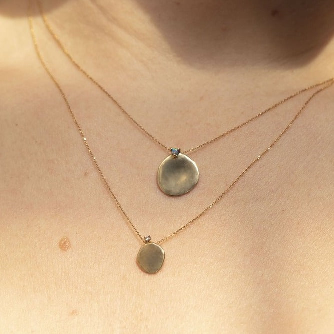 Wwake gold disc pendant necklace with diamond on model, front view