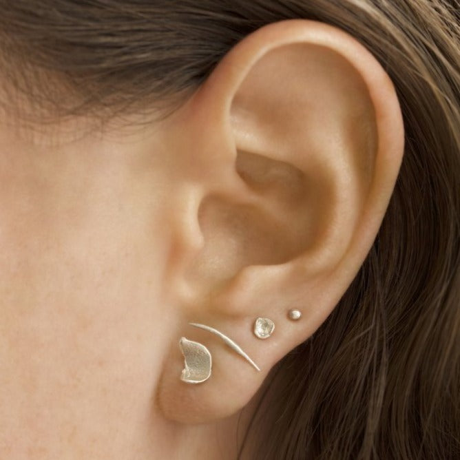 Wwake gold stud stick earring on model, front view