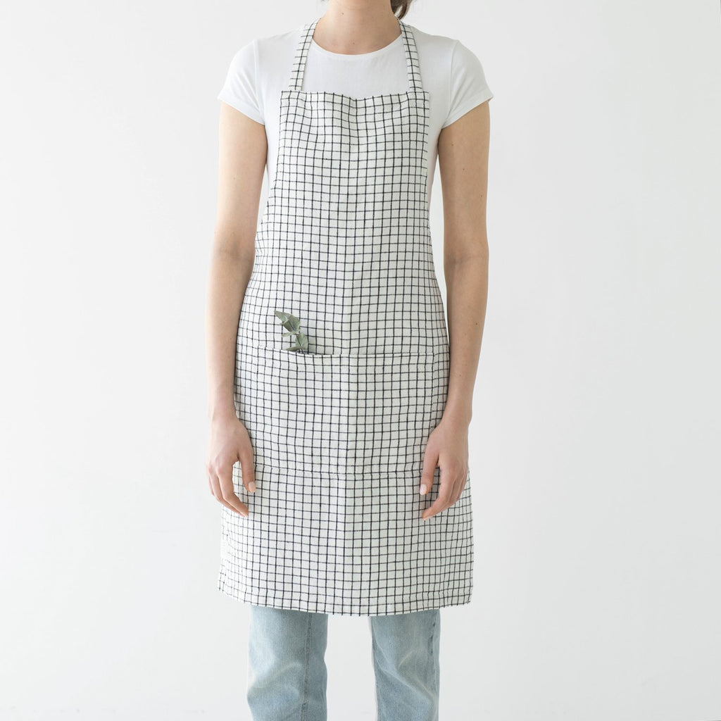 Linen Tales black and white checker apron on model, front view