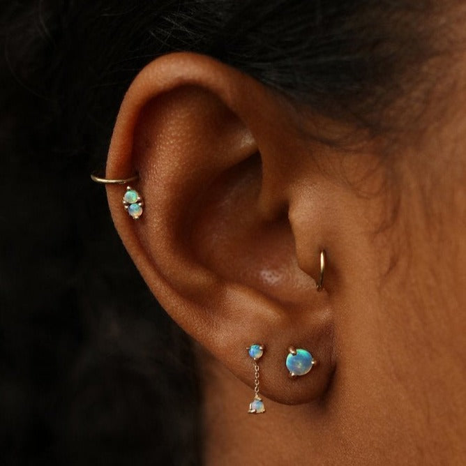 Wwake gold chain earring with 2 opals on model, front view