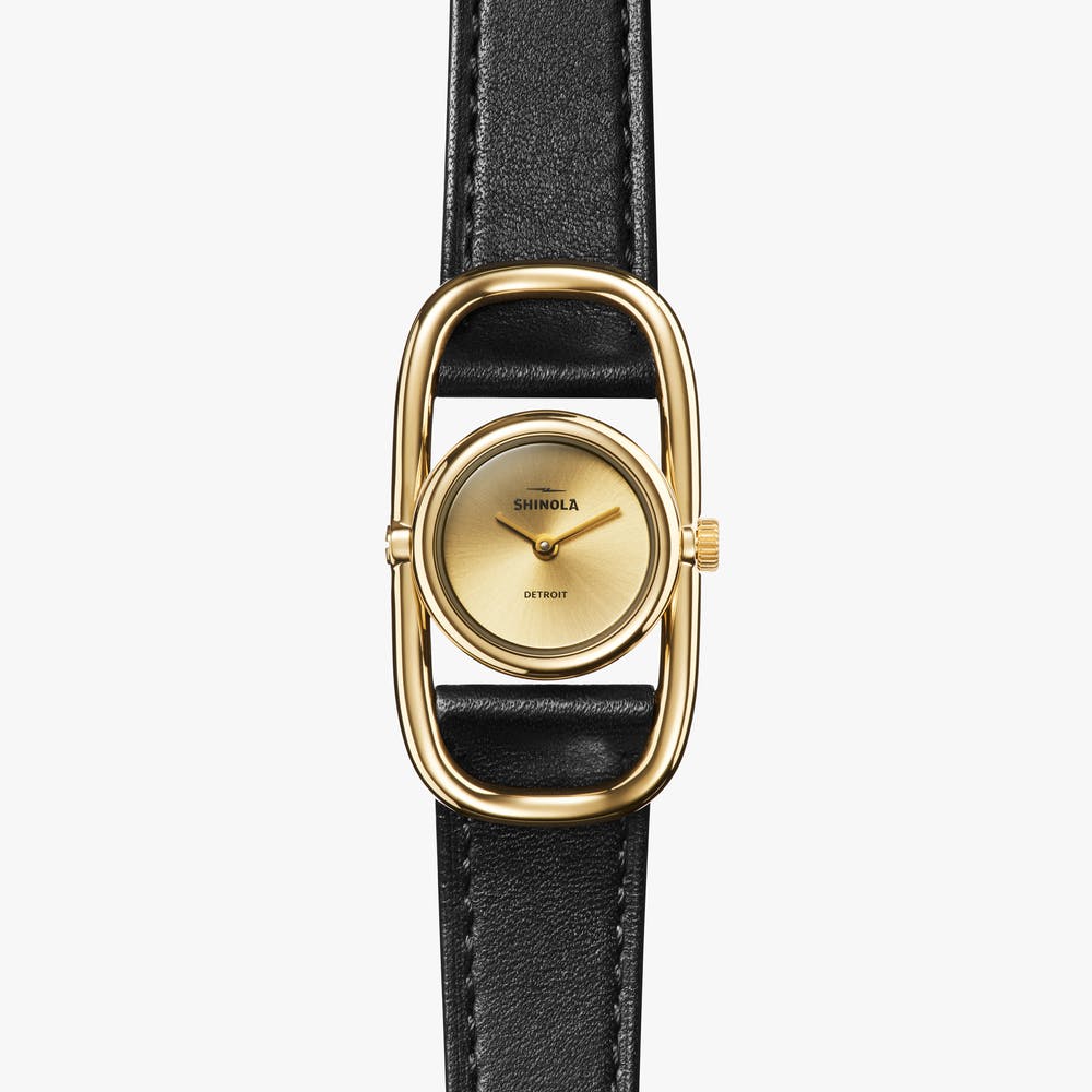 Shinola gold watch with black leather strap, front view