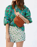 Clare V. brown leather fanny pack on model, front view