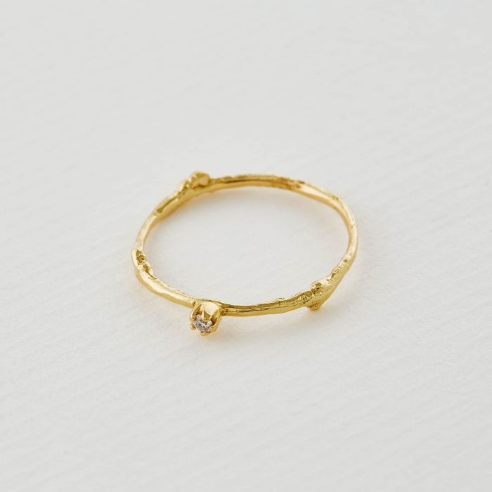 Alex Monroe textured gold band with diamond, top view