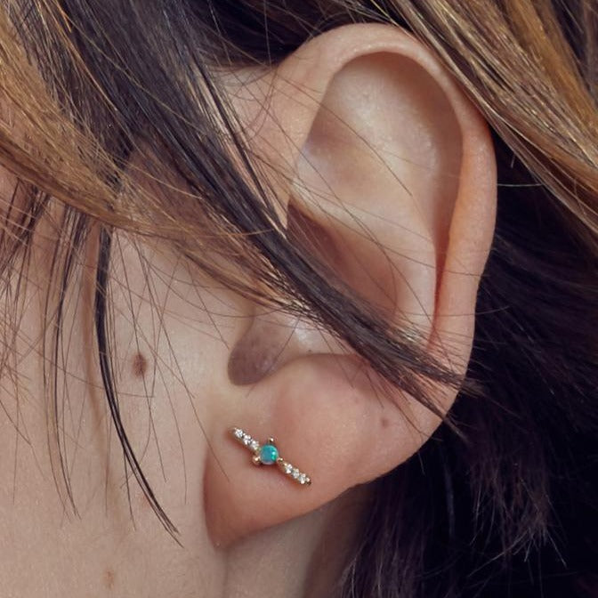 Wwake pave diamond bar stud earring with opal on model, front view
