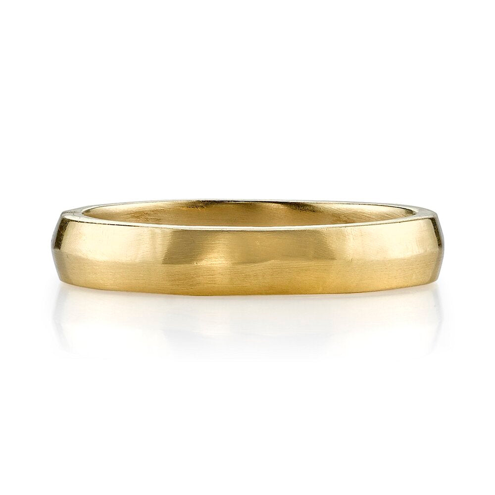 A yellow gold wedding band with a soft peaked design.