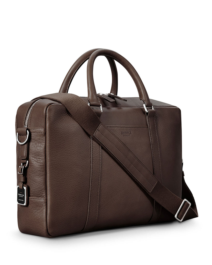 Shinola brown leather briefcase with sterling silver hardware, angled side view
