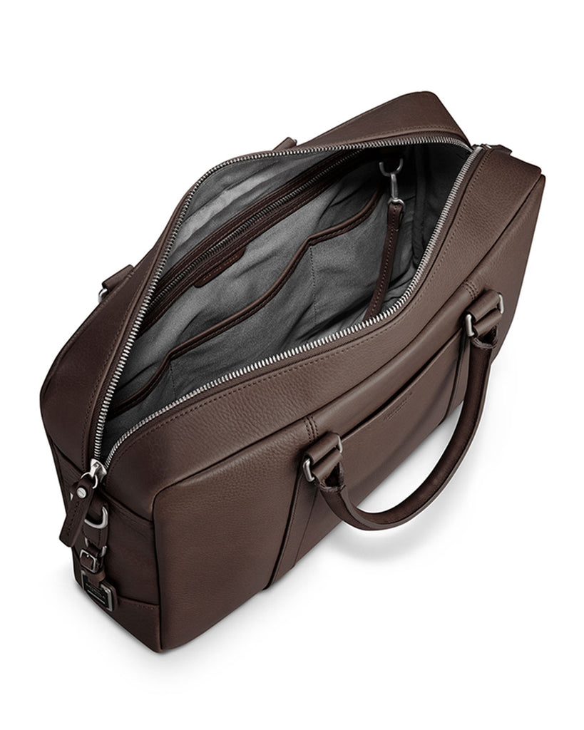 Shinola brown leather briefcase unzipped with sterling silver hardware, top view