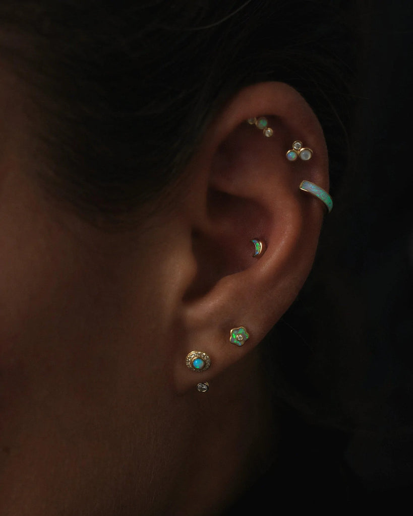 Pamela Love gold huggie earring with opal, on model front view