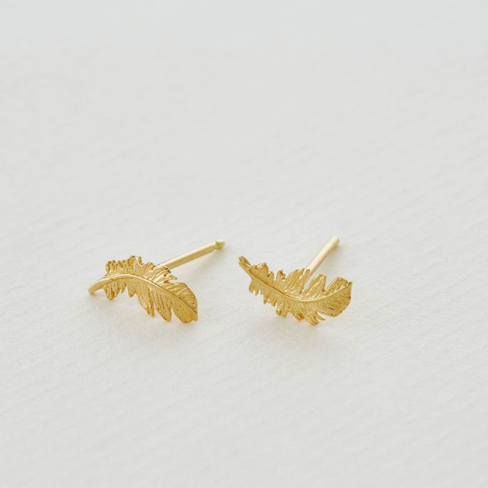 Alex Monroe gold stud feather earrings, angled top view