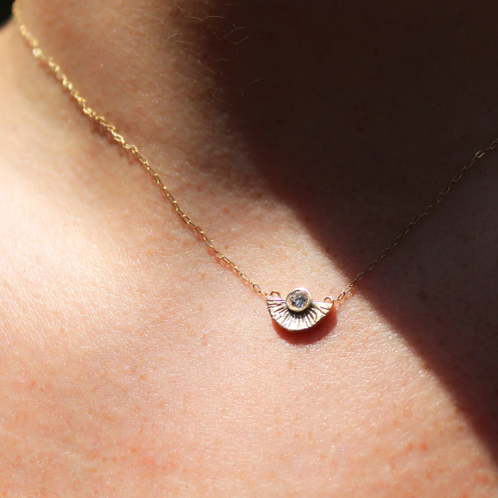 Miarante gold fan shaped necklace with diamond on model, front view
