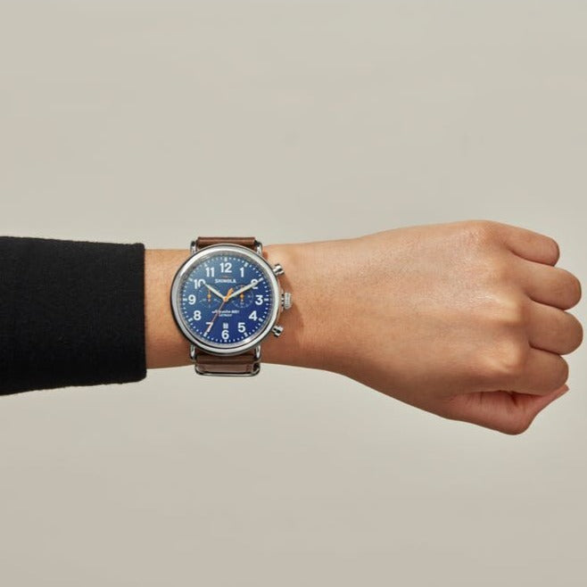 Shinola blue watch stainless steel with brown leather strap on model's arm, front view