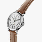 Shinola white face stainless steel watch brown leather strap, angled front view