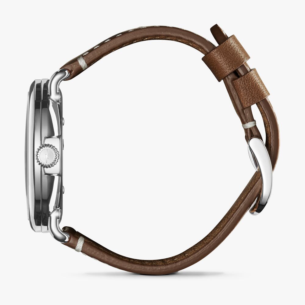 Shinola cream stainless steel watch with brown leather strap, side view