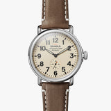 Shinola cream stainless steel watch with brown leather strap, front view