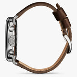 Shinola silver watch stainless steel with brown leather strap, side view