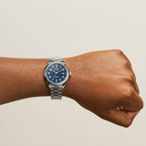 Shinola blue watch stainless steel case and strap on model's arm, front view