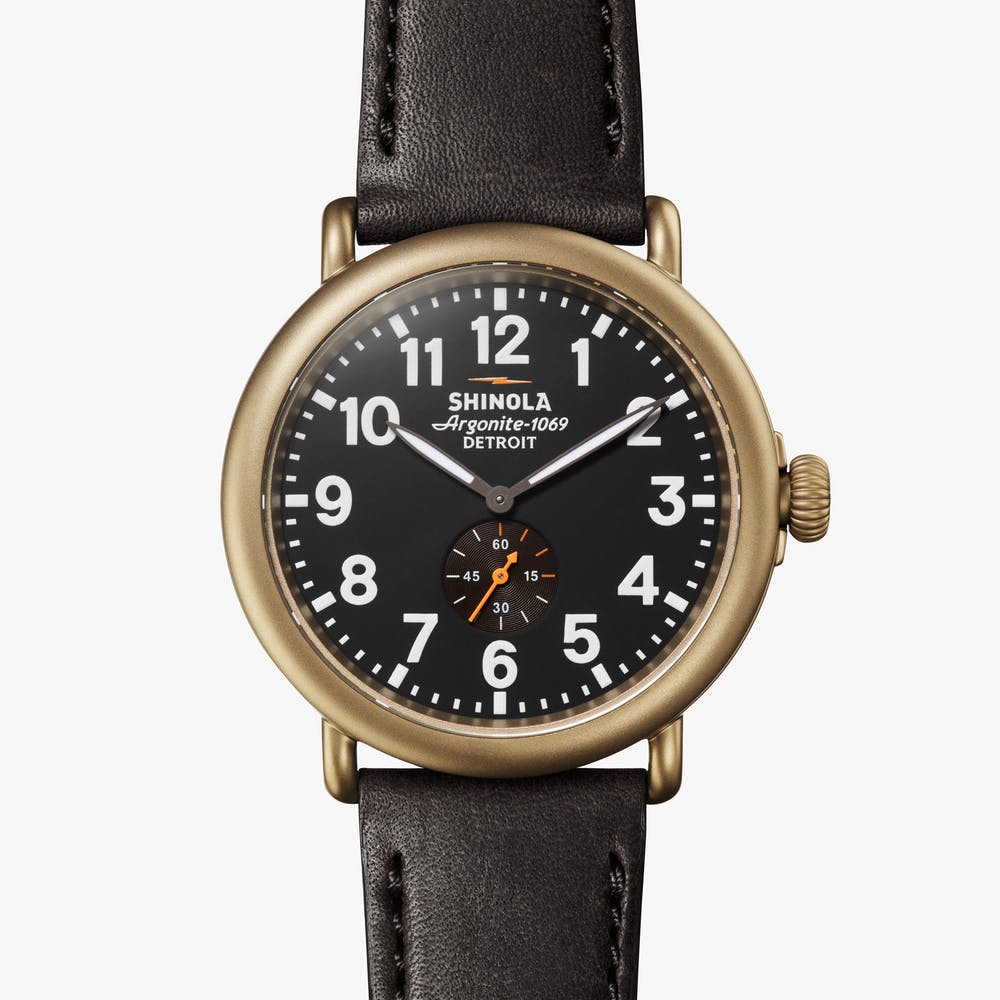 Shinola black watch face gold case with black leather strap, front view