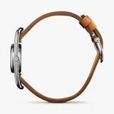 Shinola silver watch with brown leather strap, side view