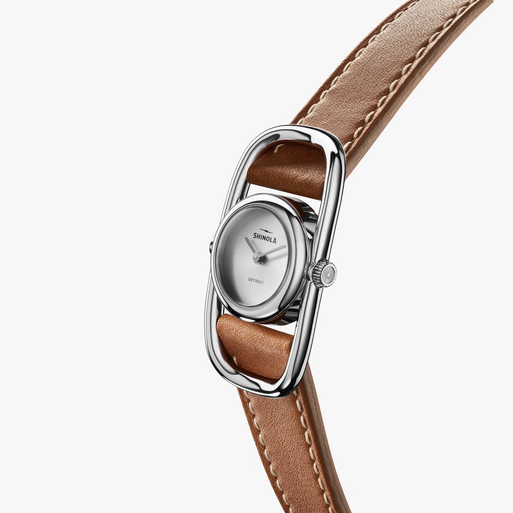 Shinola silver watch with brown leather strap, angled front view