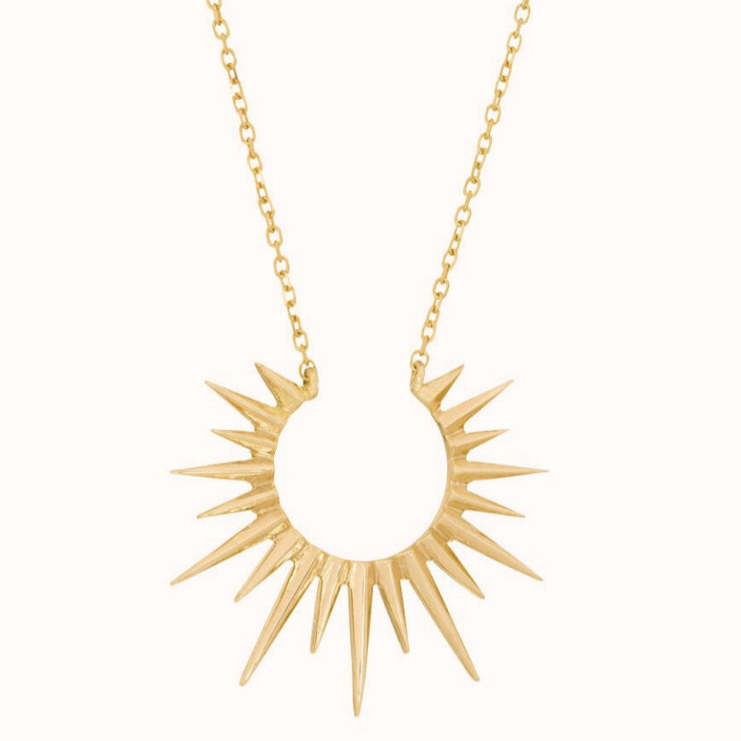 Celine D'aoust gold necklace with sunburst, front view