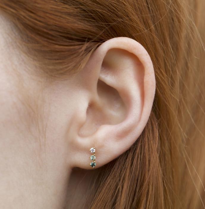 Wwake gold stud earring with 2 tourmalines and 1 diamond on model, front view