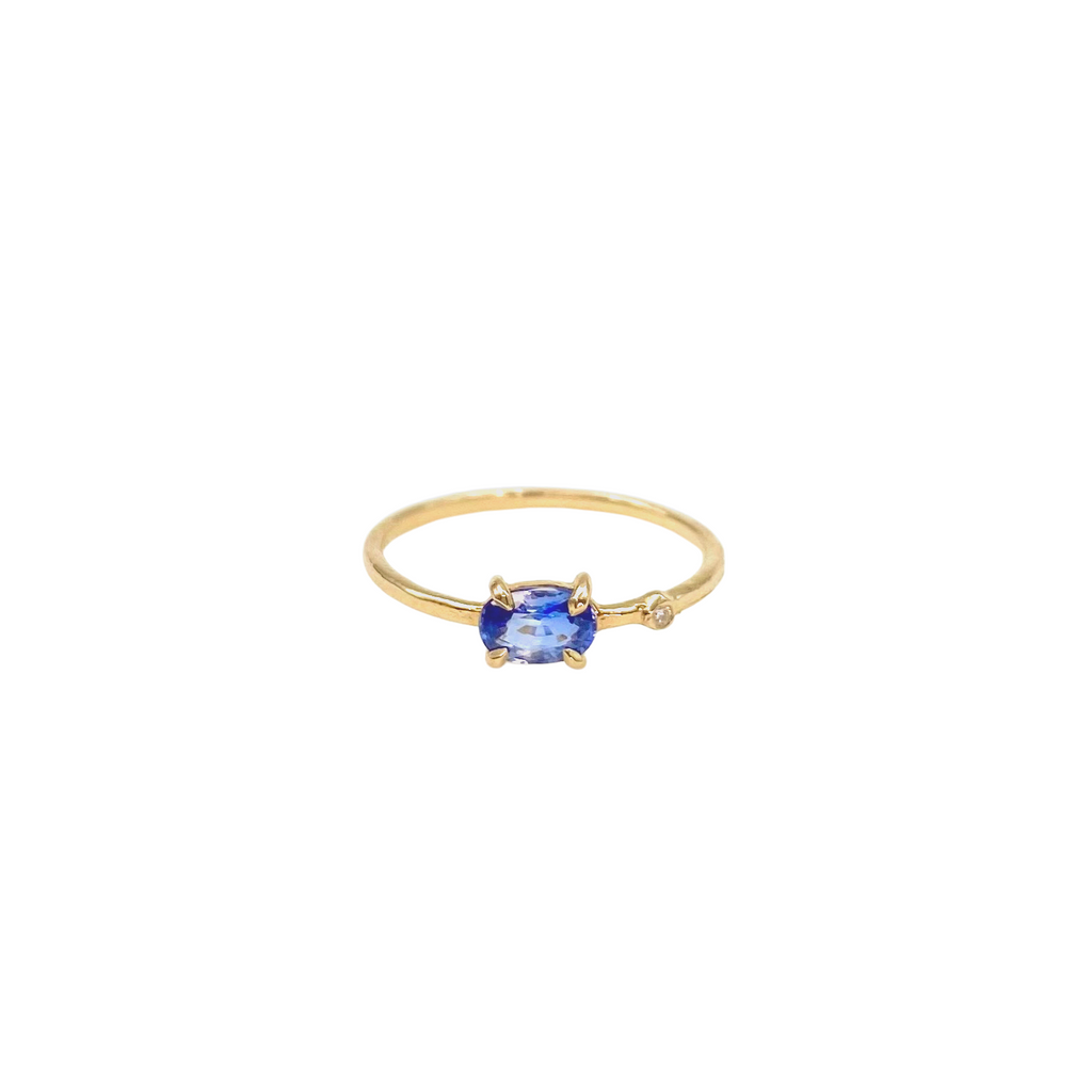 small oval blue spinel ring with inset diamond in the band front view