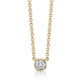 A bezel set cushion cut diamond in yellow gold on a cable chain necklace.
