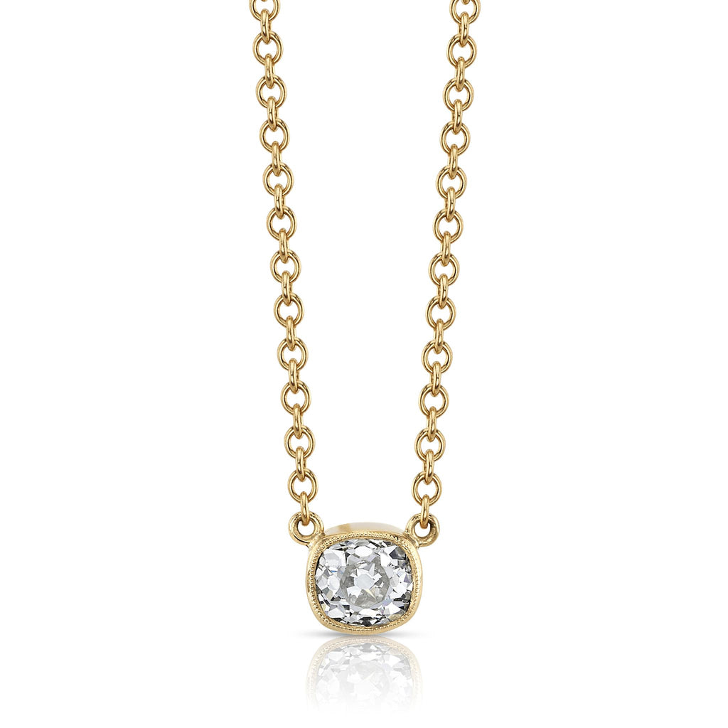 A bezel set cushion cut diamond in yellow gold on a cable chain necklace.