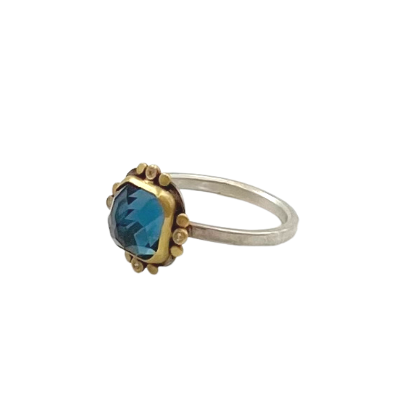 Ananda Khalsa silver ring with blue topaz, gold and diamond, angled front view
