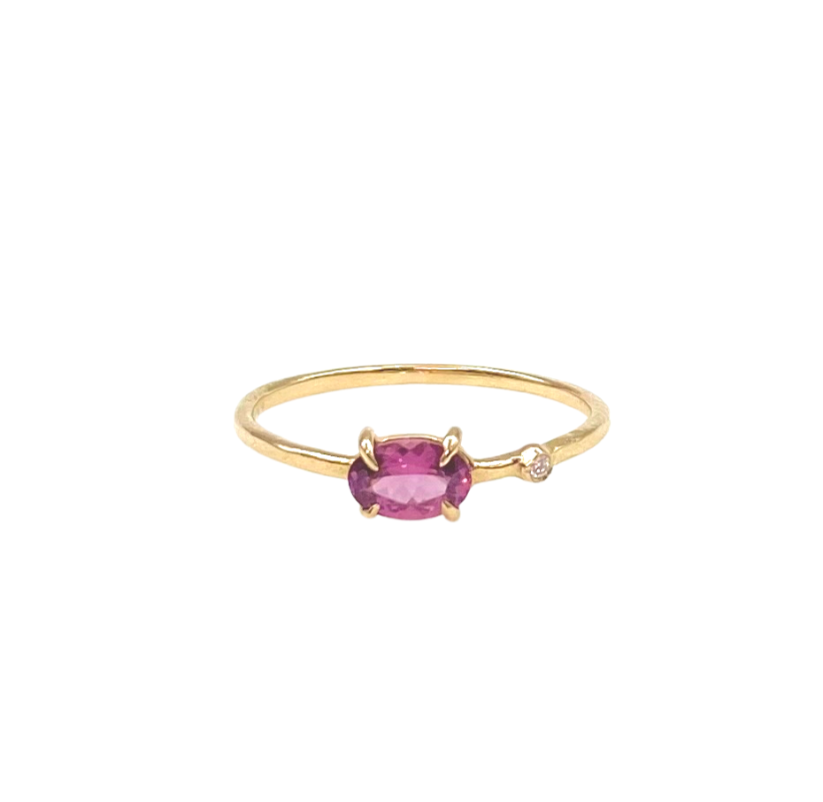 small oval pink spinel ring with inset diamond front view
